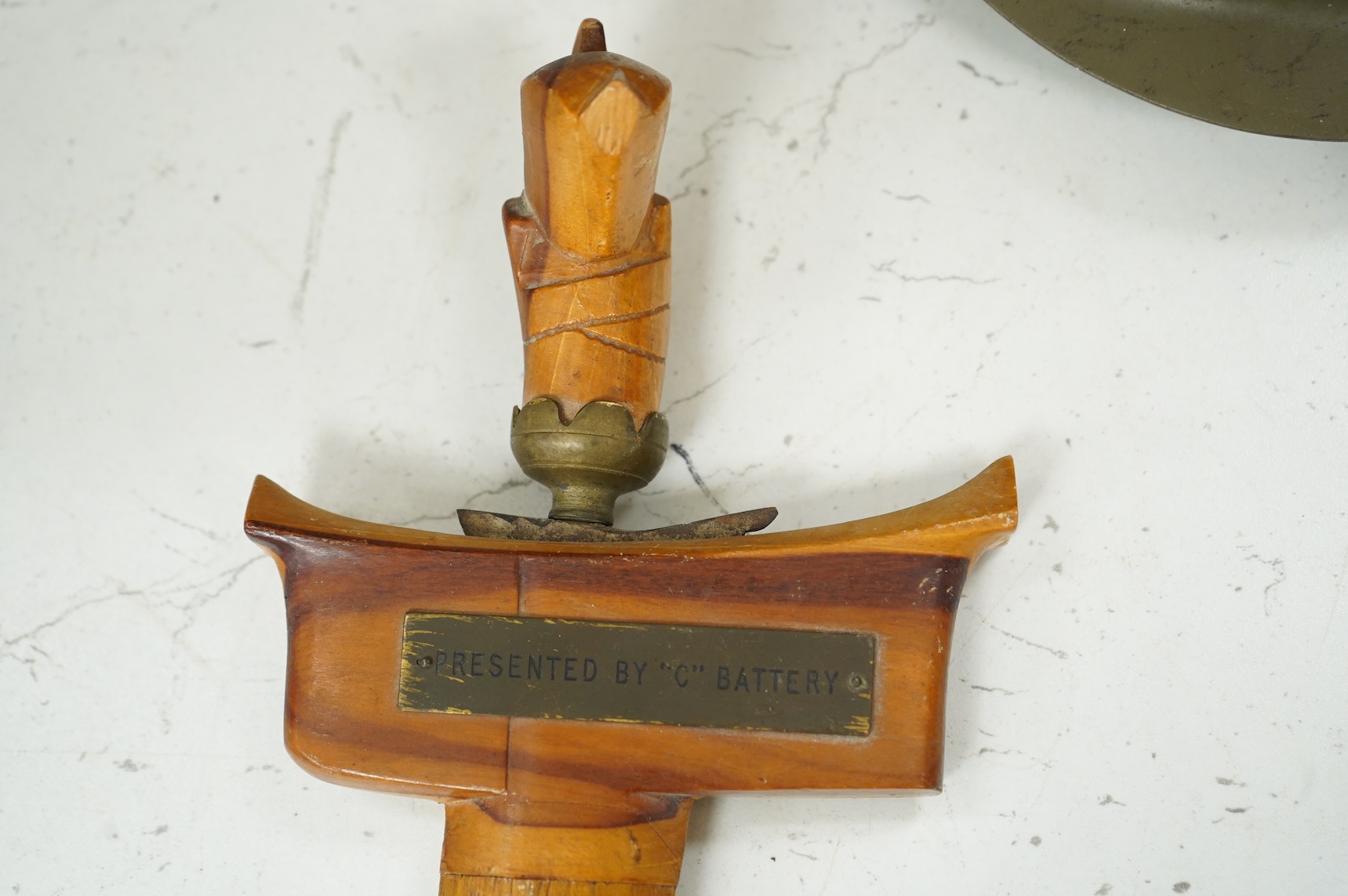 A Czech Vz53 tin helmet with liner, a Kris with applied presentation plaque engraved with ‘Presented by 'C' Battery’ and an inert British Mills hand grenade